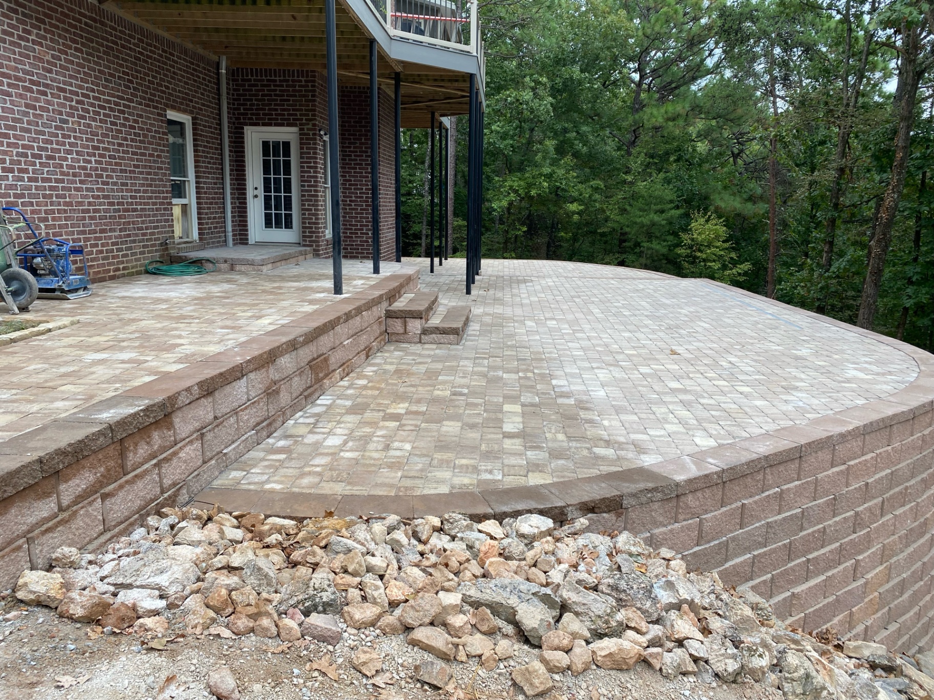 Retaining wall and stairs paired with an elevated patio