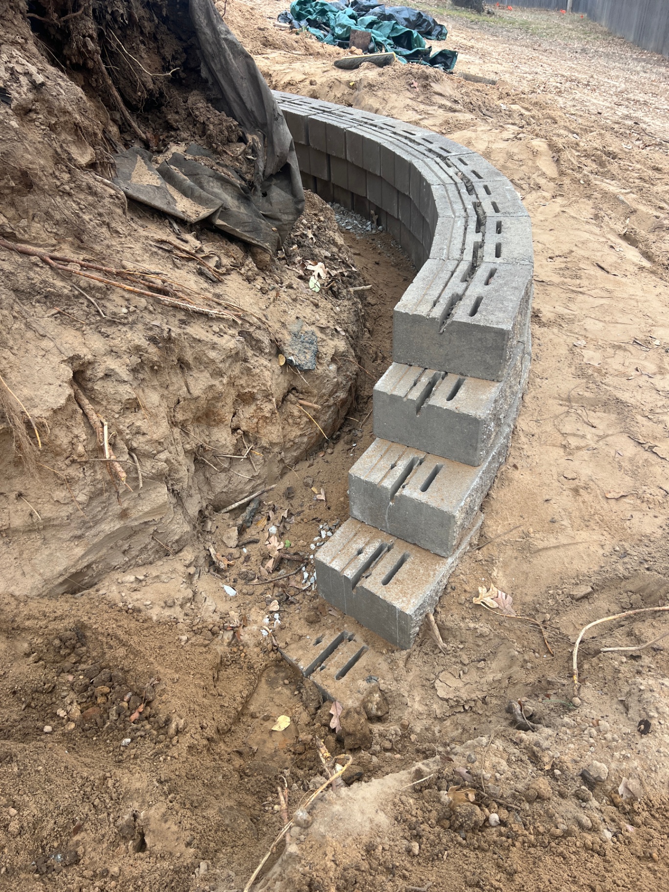 Curved retaining wall layout in progress during installation